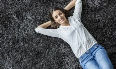 Lady Laying on Carpet | Ron's Carpet & Design